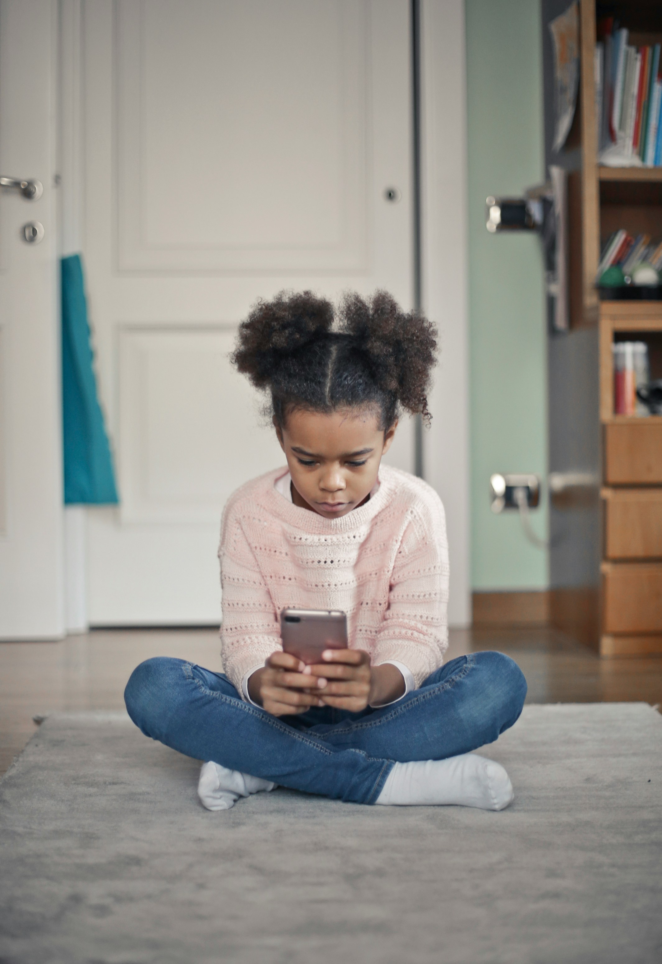 A child reading on a phone with ReDirect